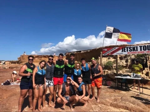 Jet ski booking hut on the rocks at Cala Comte Ibiza with clients preparing for jet ski tour
